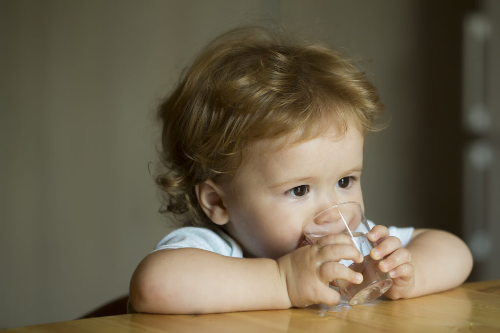 infant drinking glass of water